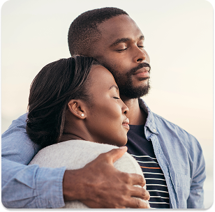 African couple side hugging