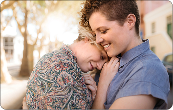 Two women hugging happily